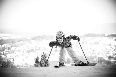 Kleines Mächden lacht bei den ersten Skiübungen